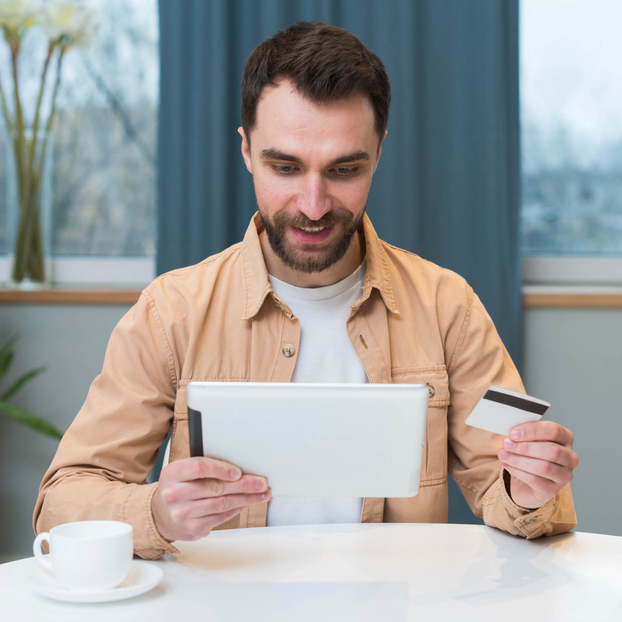 Front view of man shopping online using tablet